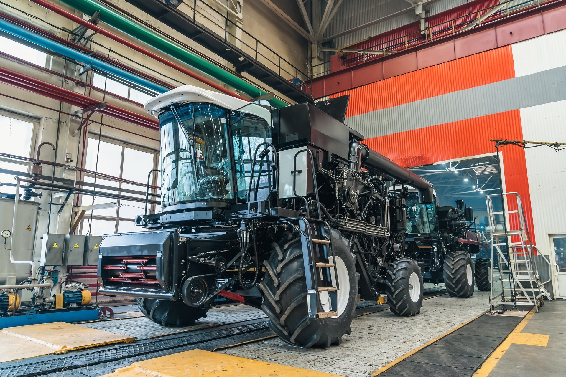 Cosechadora agrícola en proceso de montaje en línea transportadora en fábrica